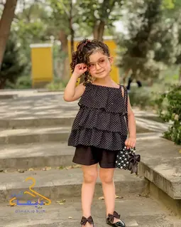 ست تاپ و شلوارک مشکی طرح چین طبقه ای توپی سفید